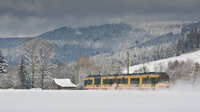 A Karlsruhe TramTrain in deep snow in the countryside.