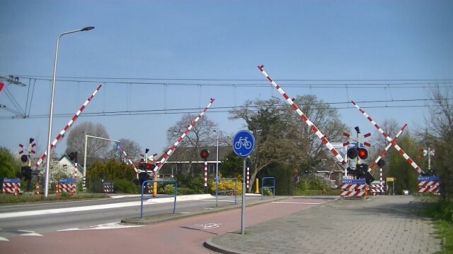 Dutch Urban rail crossing protected by gates for both cars n cyclists and pedestrians.