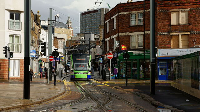 Croydon Tram at Reeves Corner, doing everything that TransLink claims trams cannot do!